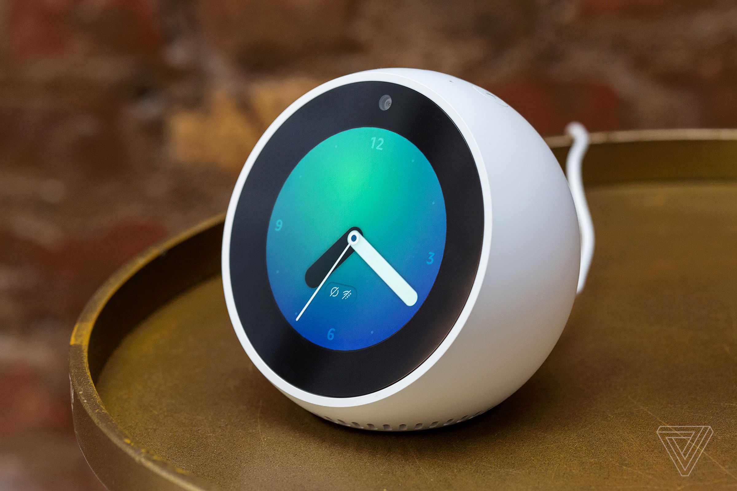 The 2017 version of the Amazon Echo Spot, a round half glove that looks like a clock on a desk.