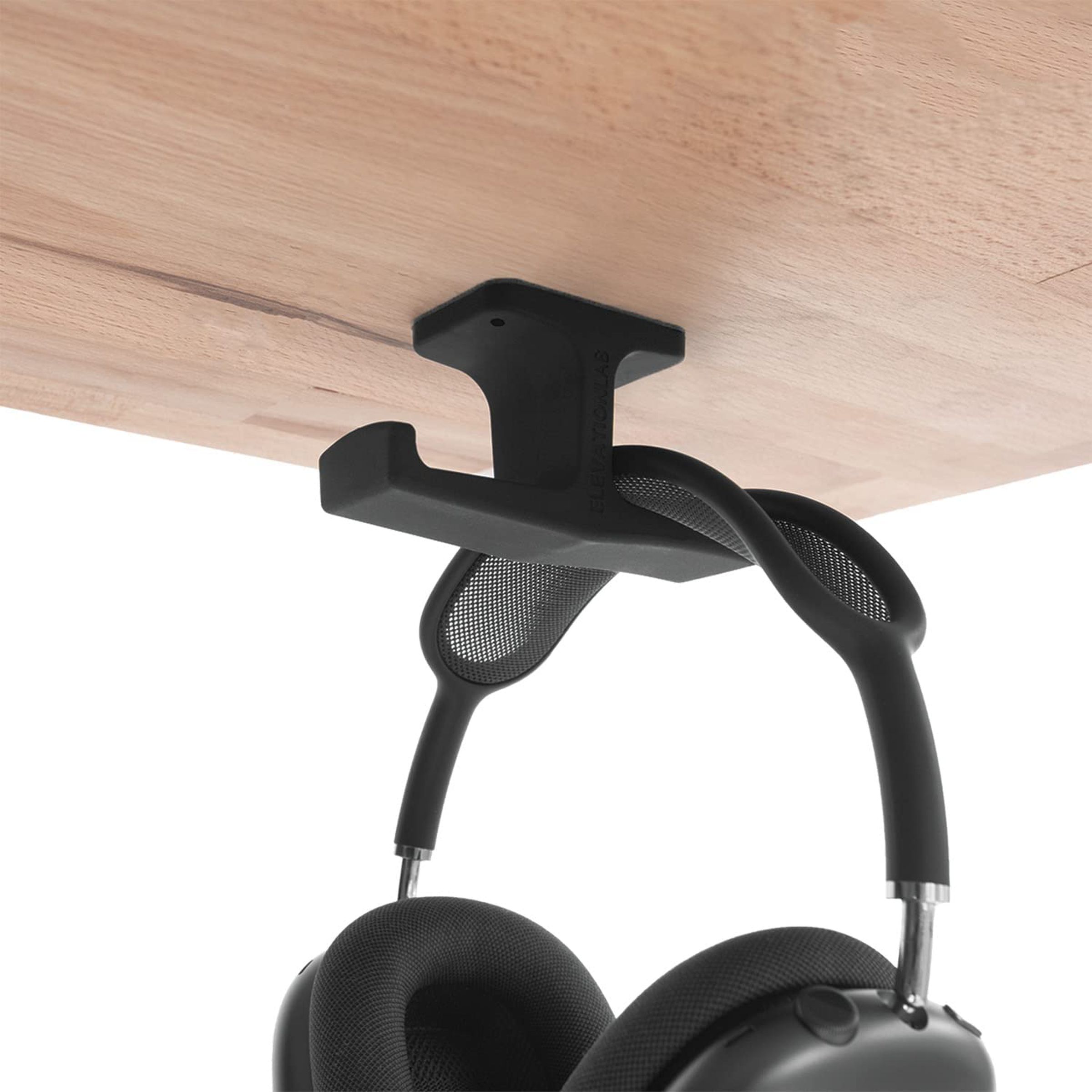 A double hook attached under a desk that holds a pair of headphones.