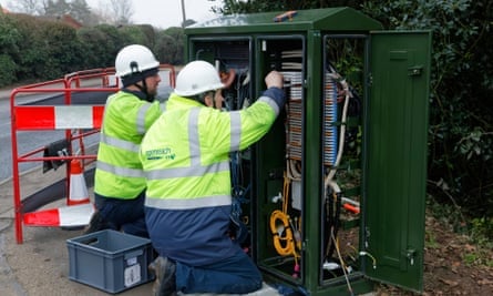 BT Openreach engineers working on a high street broadband internet fiber cabinet