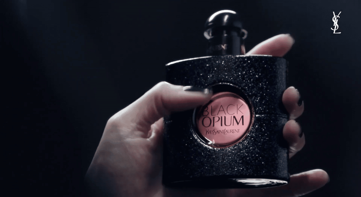 a person with a Yves Saint Laurent "black opium" fragrance, for which the latest NFT campaign will be launched.
