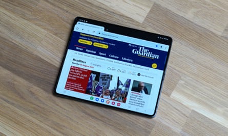 The Guardian site is displayed in a full-size tablet view on the Z Fold 4 in landscape orientation.