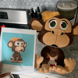image of the nft monkey next to the stuffed monkey