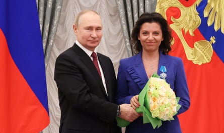 Vladimir Putin awards a prize to Margarita Simonyan, editor-in-chief of RT, in December 2022.