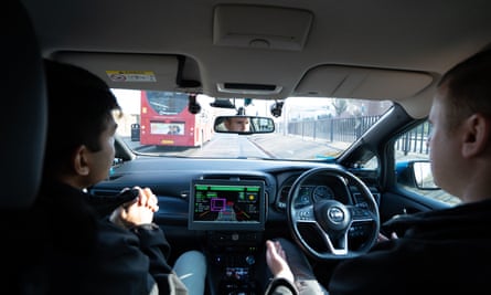A Nissan Leaf drives on public roads in Woolwich, south-east London, during a self-driving car test.