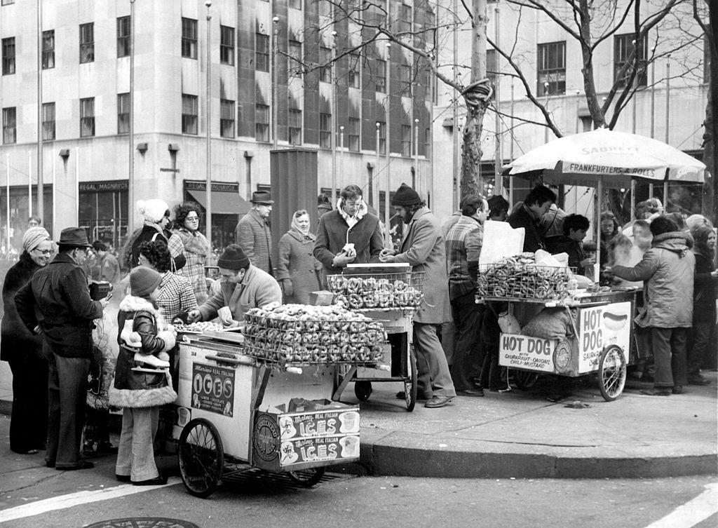 December 1975 - Street vendors selling pretzels and hot dogs in New York