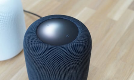 Apple HomePod with its top panel illuminated.