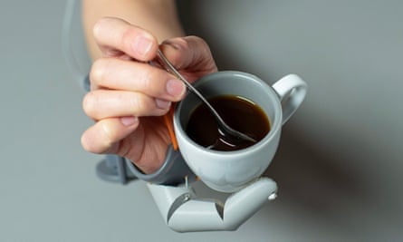 robotic thumb holding a cup of coffee