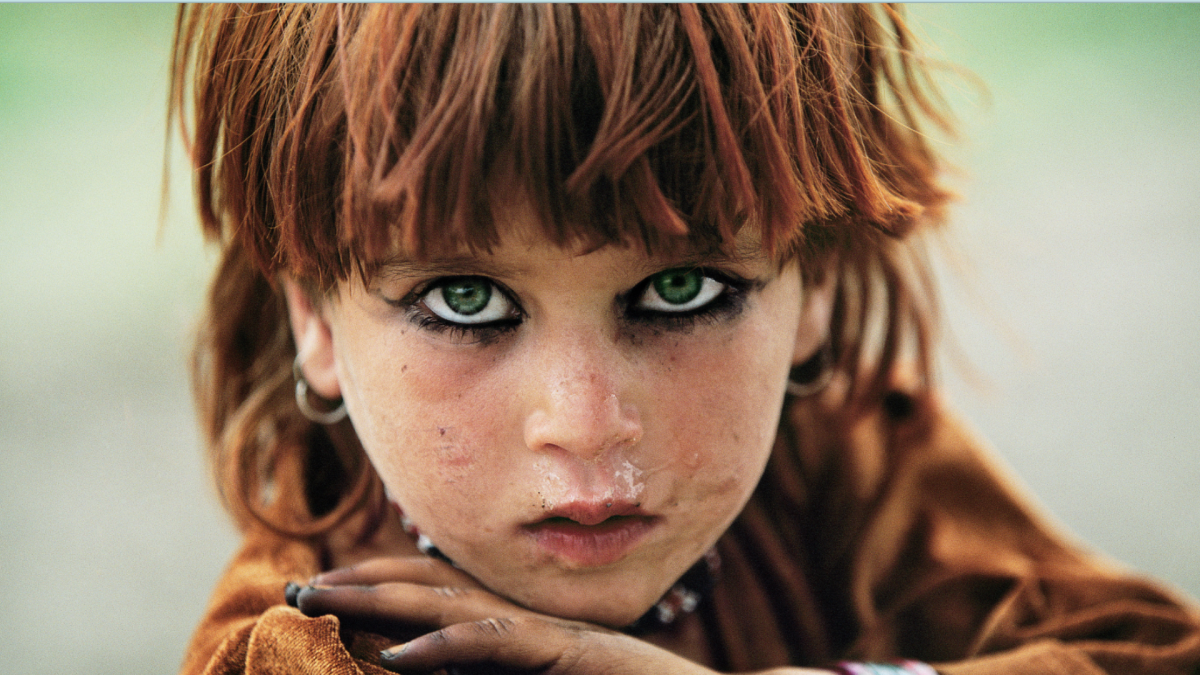 a photo of a girl with green eyes staring into the camera, from REZA's debut NFT photo collection