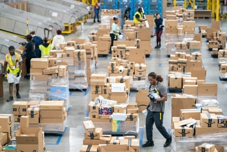 Workers sort packages by zip code during a media tour of the Amazon AGS5 facility in Appling, Georgia on October 27, 2022.