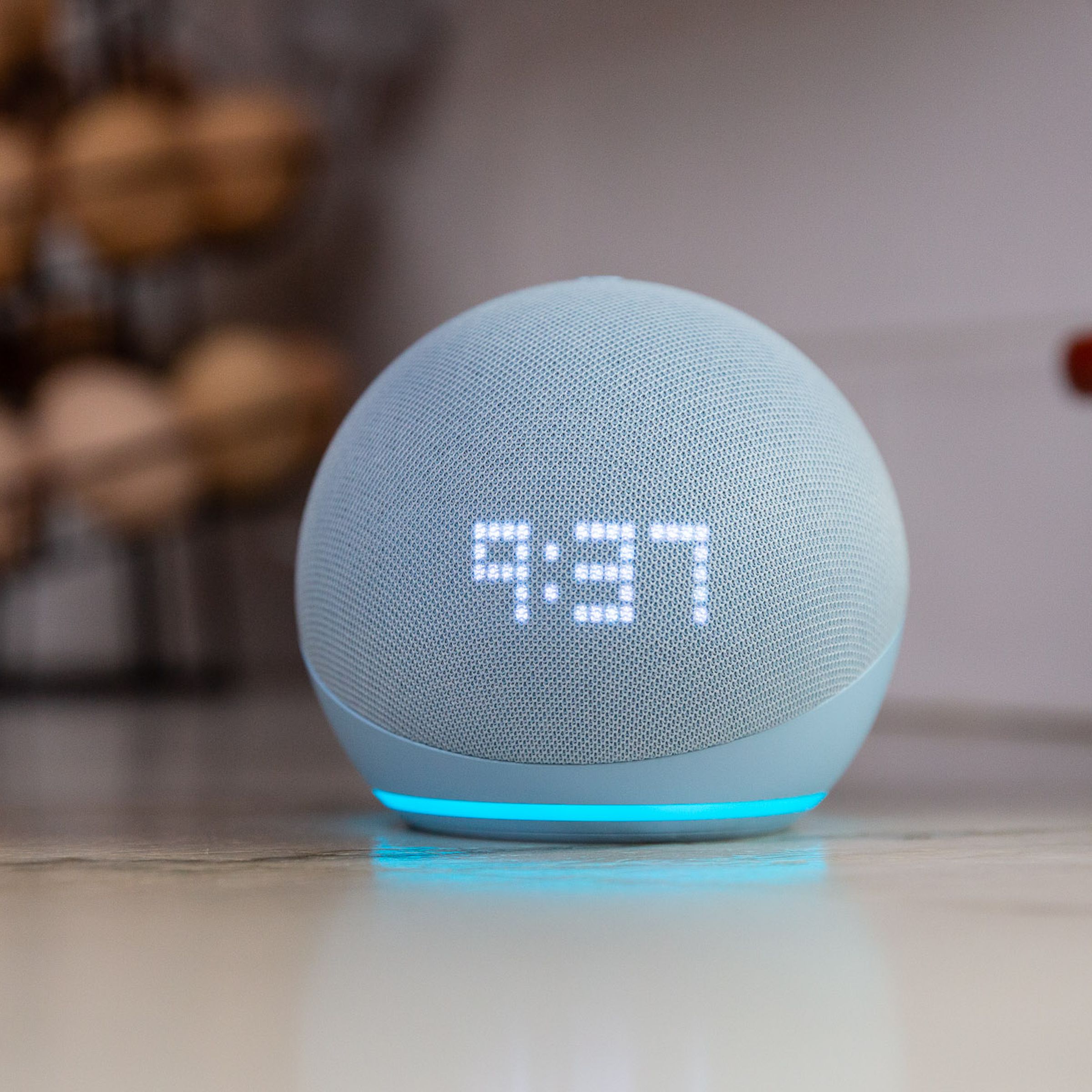 An echo dot with clock on a desk