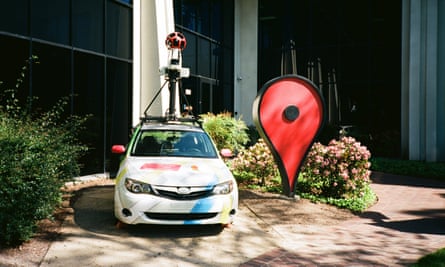 A Google Street View car and an oversized Google Maps pin parked in front of the Google Maps building at the Googleplex, the headquarters of Google in Mountain View, California.