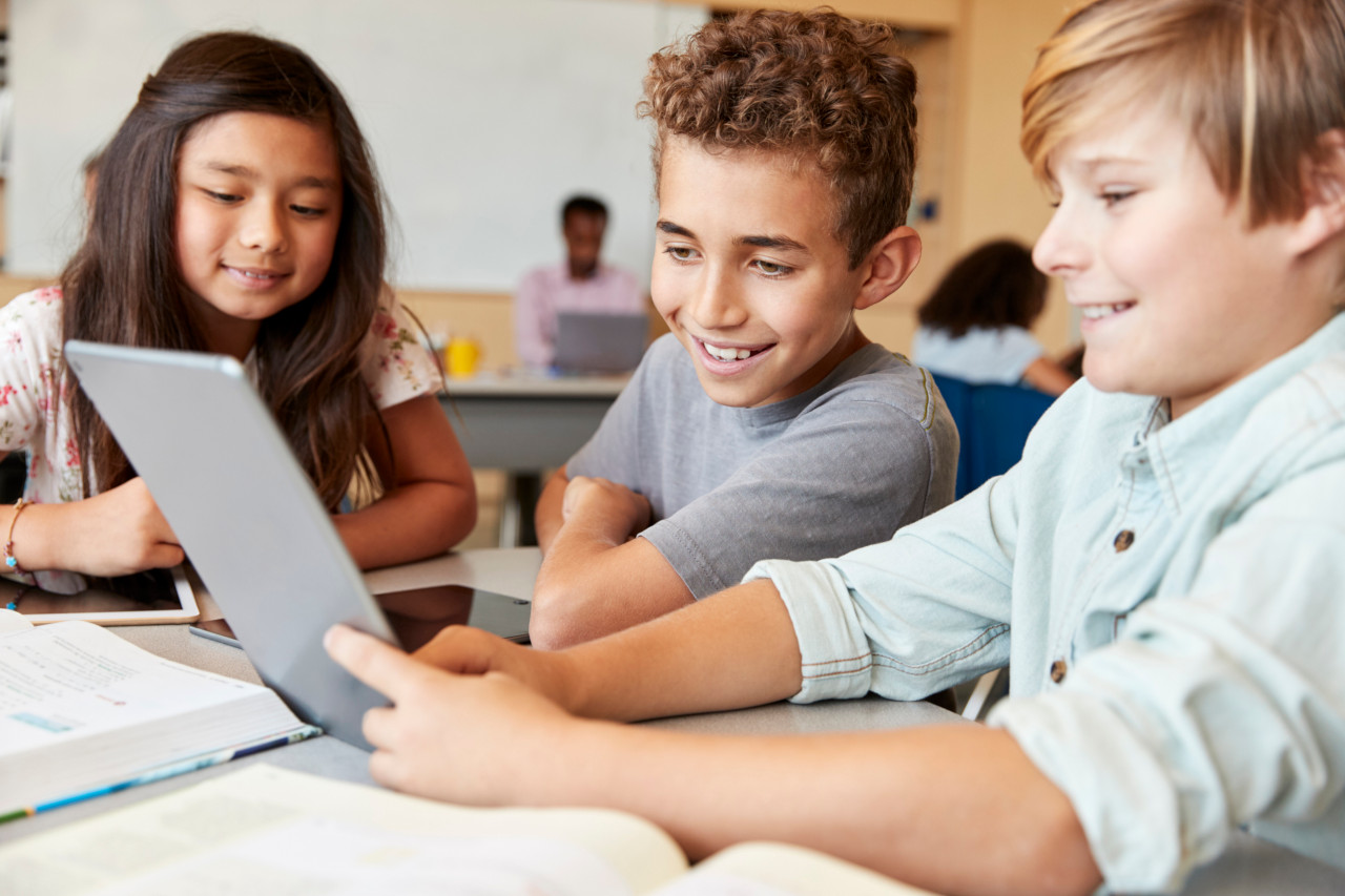 Primary school children using tablet in school class