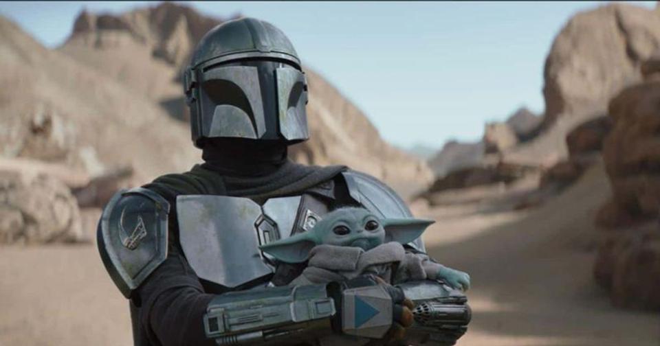 Din Djarin holding Grogu in season 3 of The Mandalorian