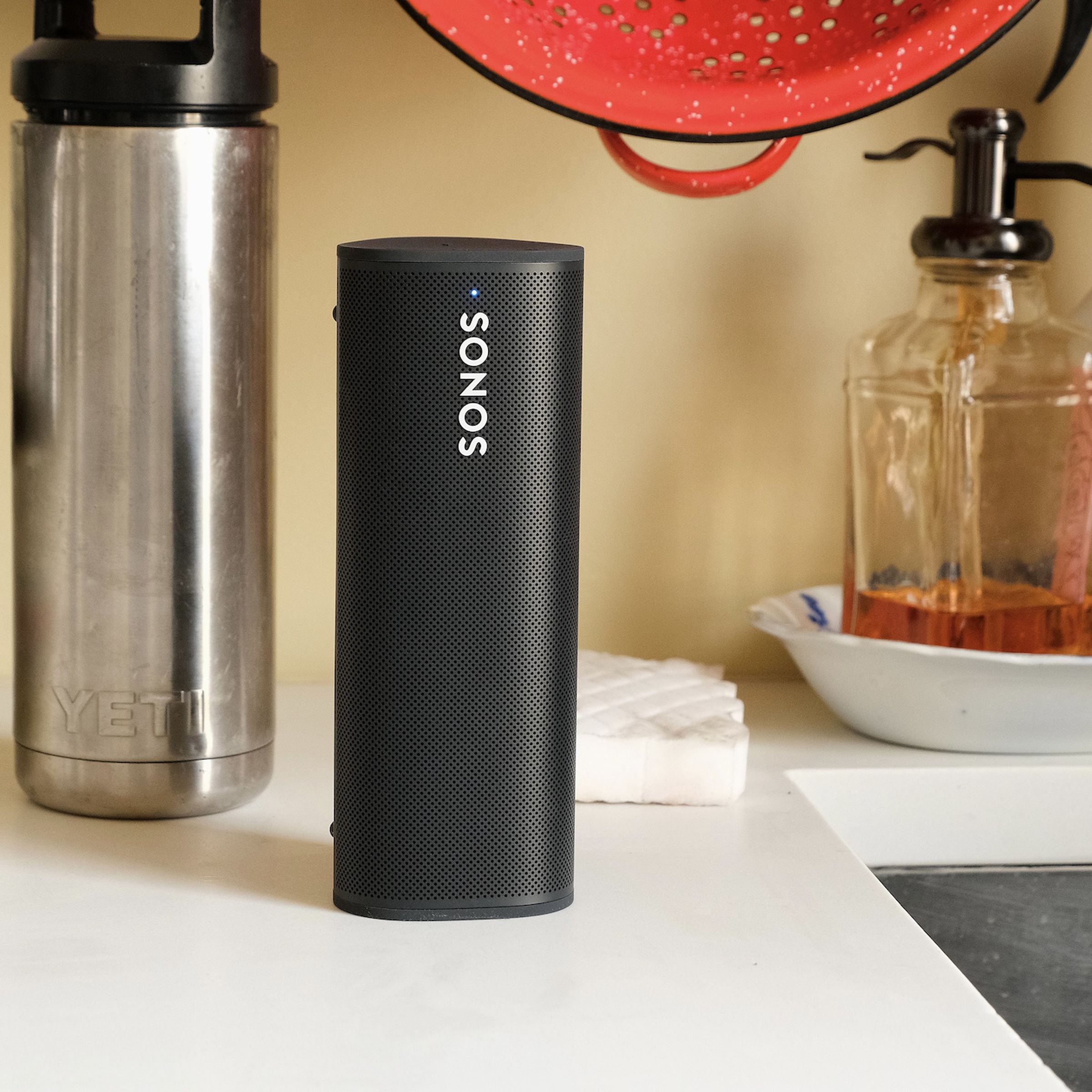 A photo of the Sonos Roam speaker on a kitchen counter.