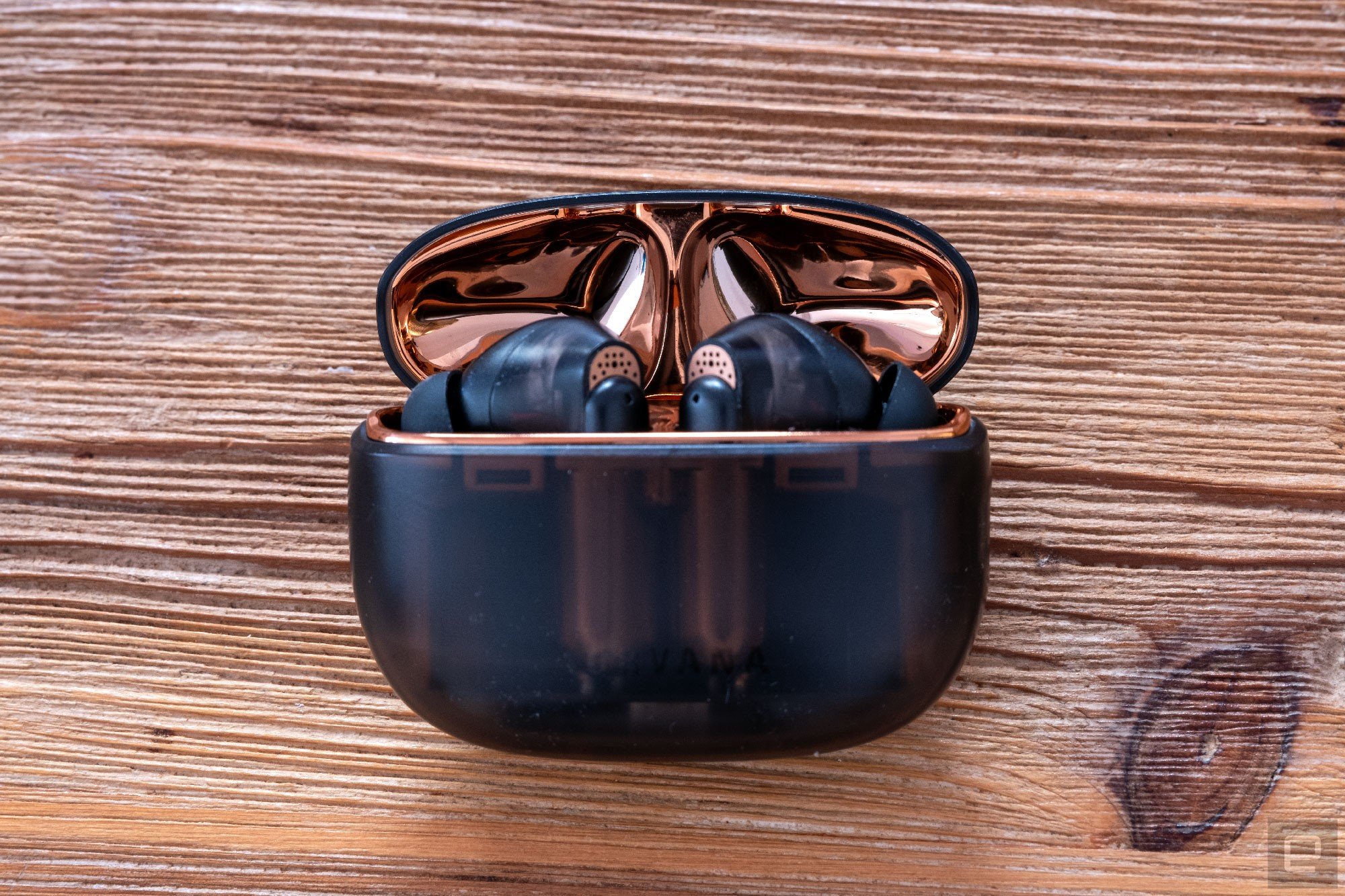 Creative's Aurvana Ace earbuds shown in their charging case.