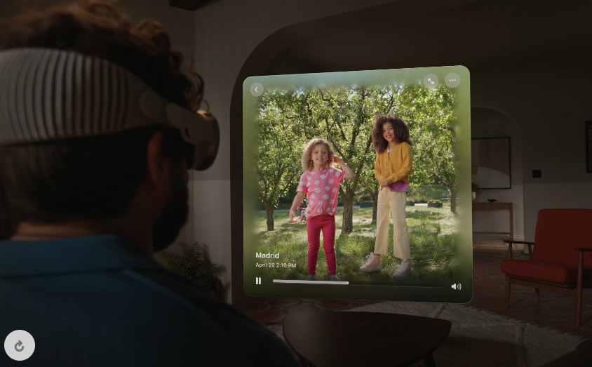 A man uses Apple Vision pro to watch a video of his children.