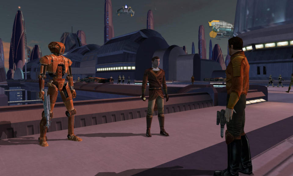 Still from Star Wars: Knights of the Old Republic.  Two people and a droid meet outside on a bridge in a very Star Wars setting.  Buildings, ships, towers.