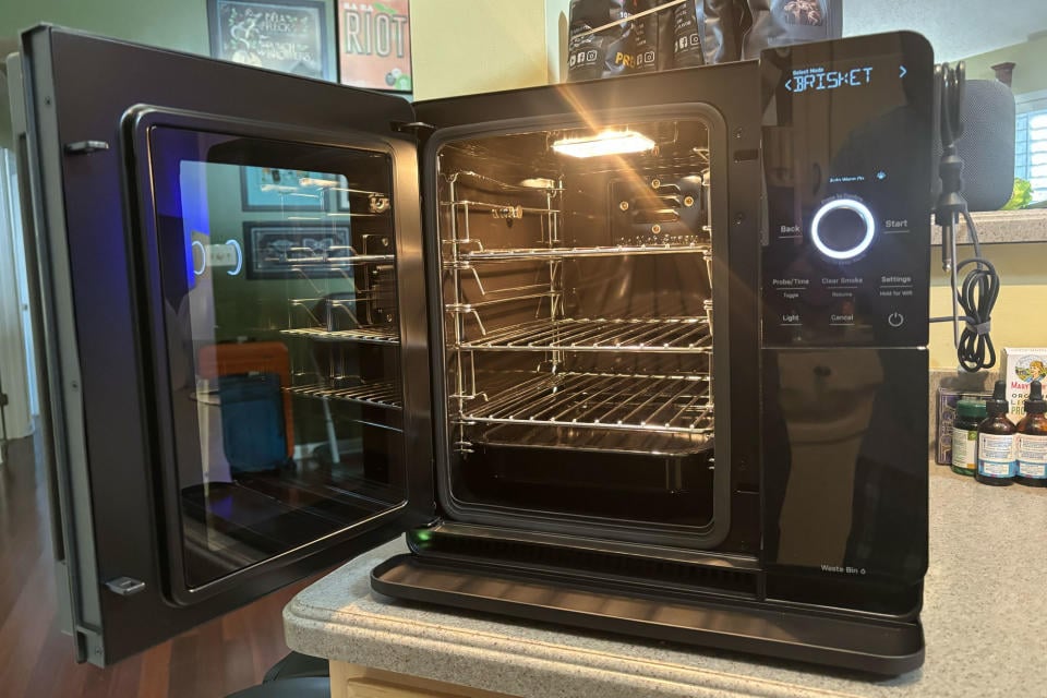 GE Profile Smart Indoor Smoker with the door open, showing the three removable racks.