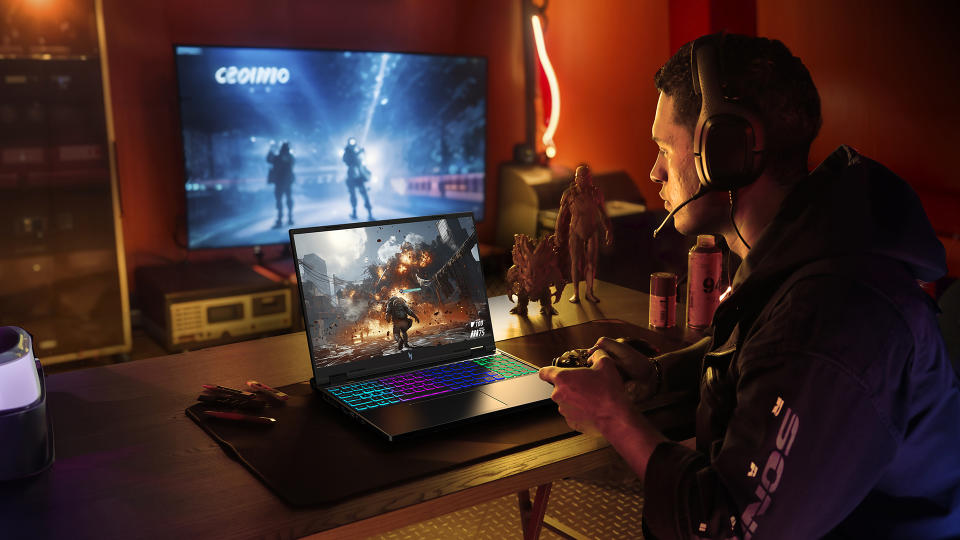 A gamer sits in a stylish gaming room with modern lighting and an Acer gaming laptop.  A second television shows a different part of a game behind them.