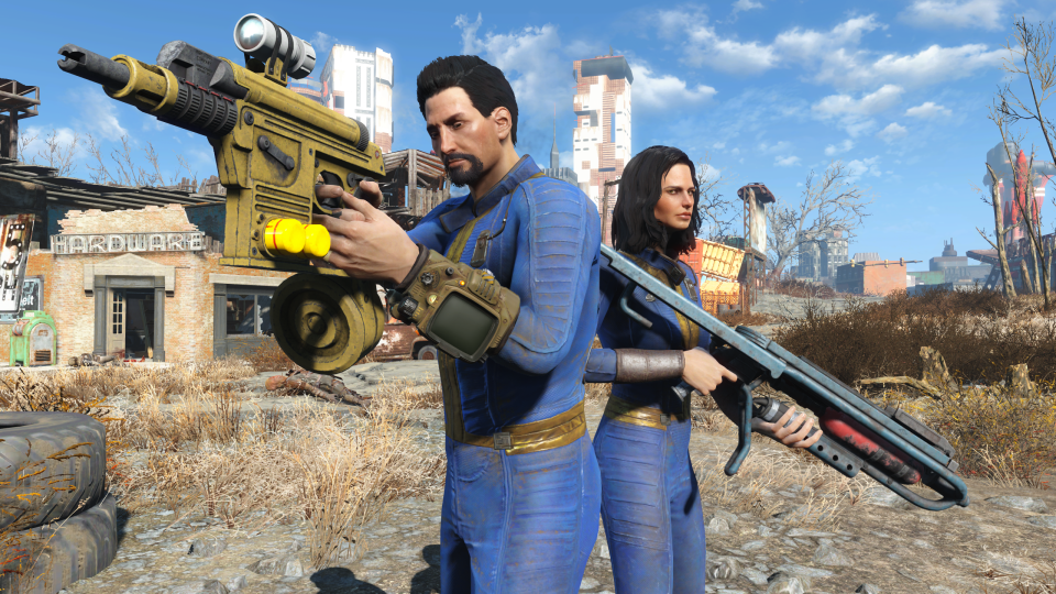 Promotional screenshot of the next-gen console update for Fallout 4. Two people (in blue suits) are armed with firearms in a video game wasteland.  Ruined buildings and a desert landscape in the background.