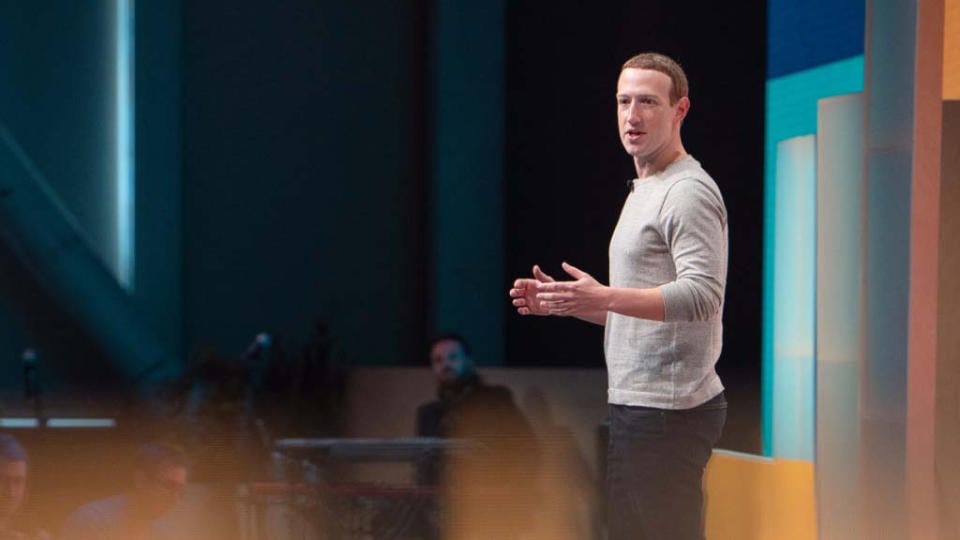 Mark Zuckerberg on stage during a company keynote presentation.  Profile view from the left side.