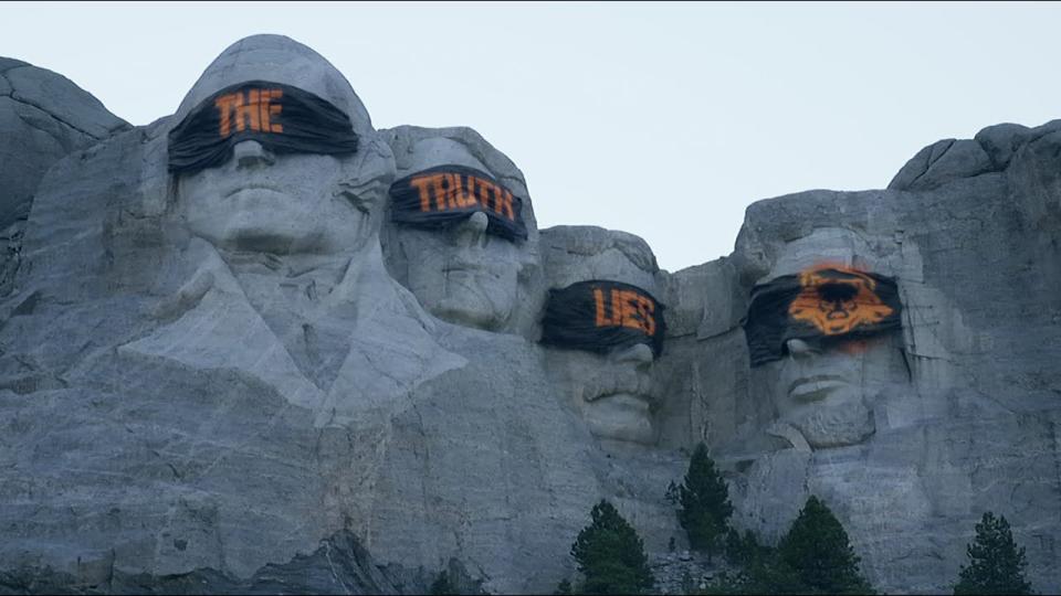 Call of Duty: Black Ops 6 marketing image. Mount Rushmore, except the presidents' eyes are covered with bandages that say 