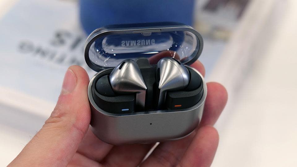 Samsung Galaxy Buds 3 Pro in hand at an event.