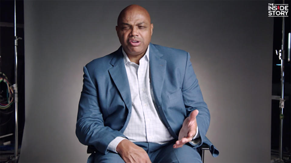 Charles Barkley sitting in a study chair, a look of disbelief on his face.