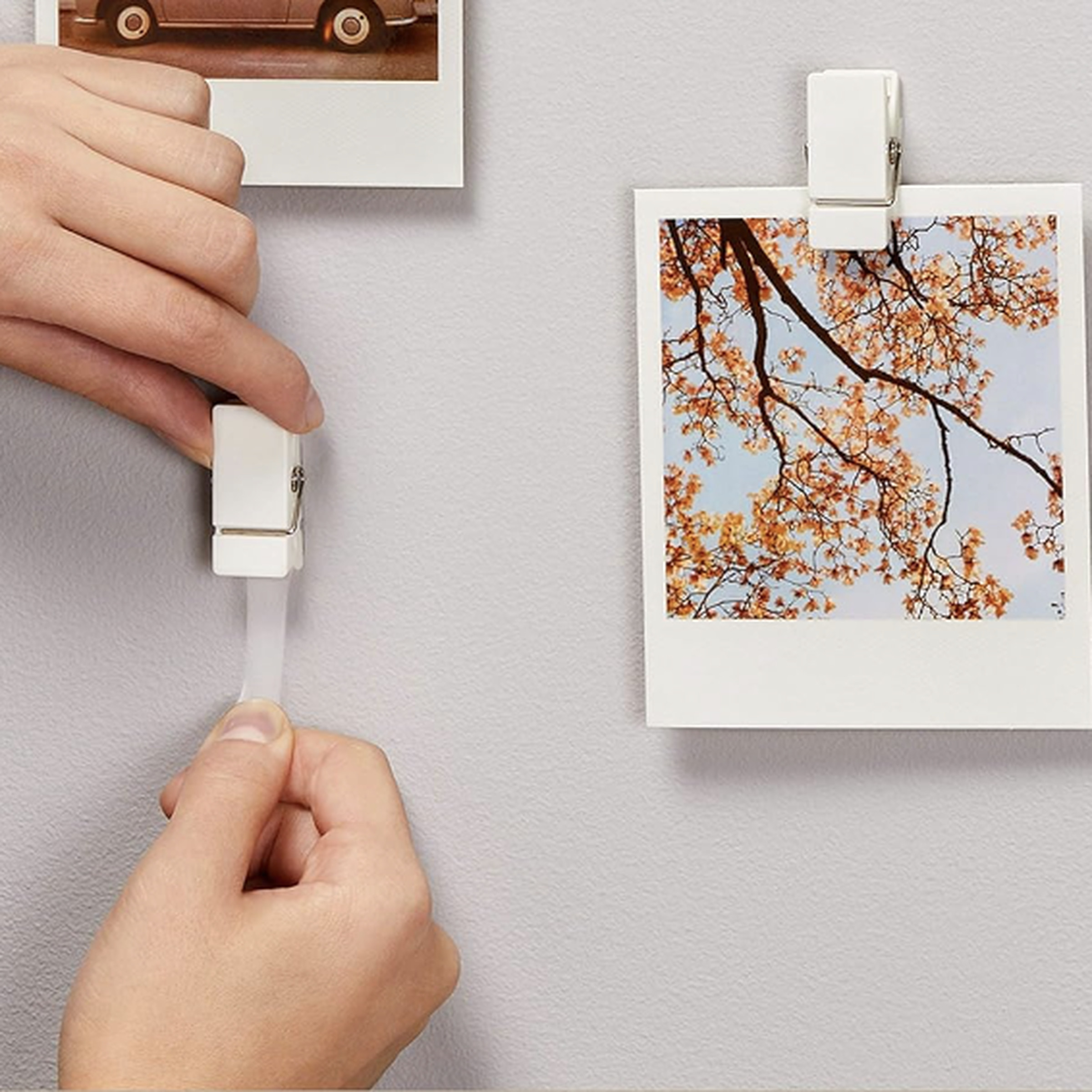 Attach the clip with tape to the wall with your hand and other clips hold the photos.