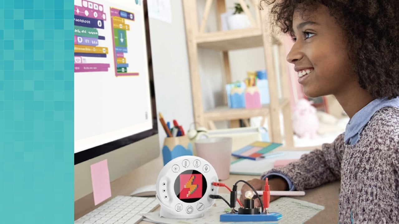 A student creates code on a computer while the Xploris Labdisc for K-8 students measures data on the desk next to her. 