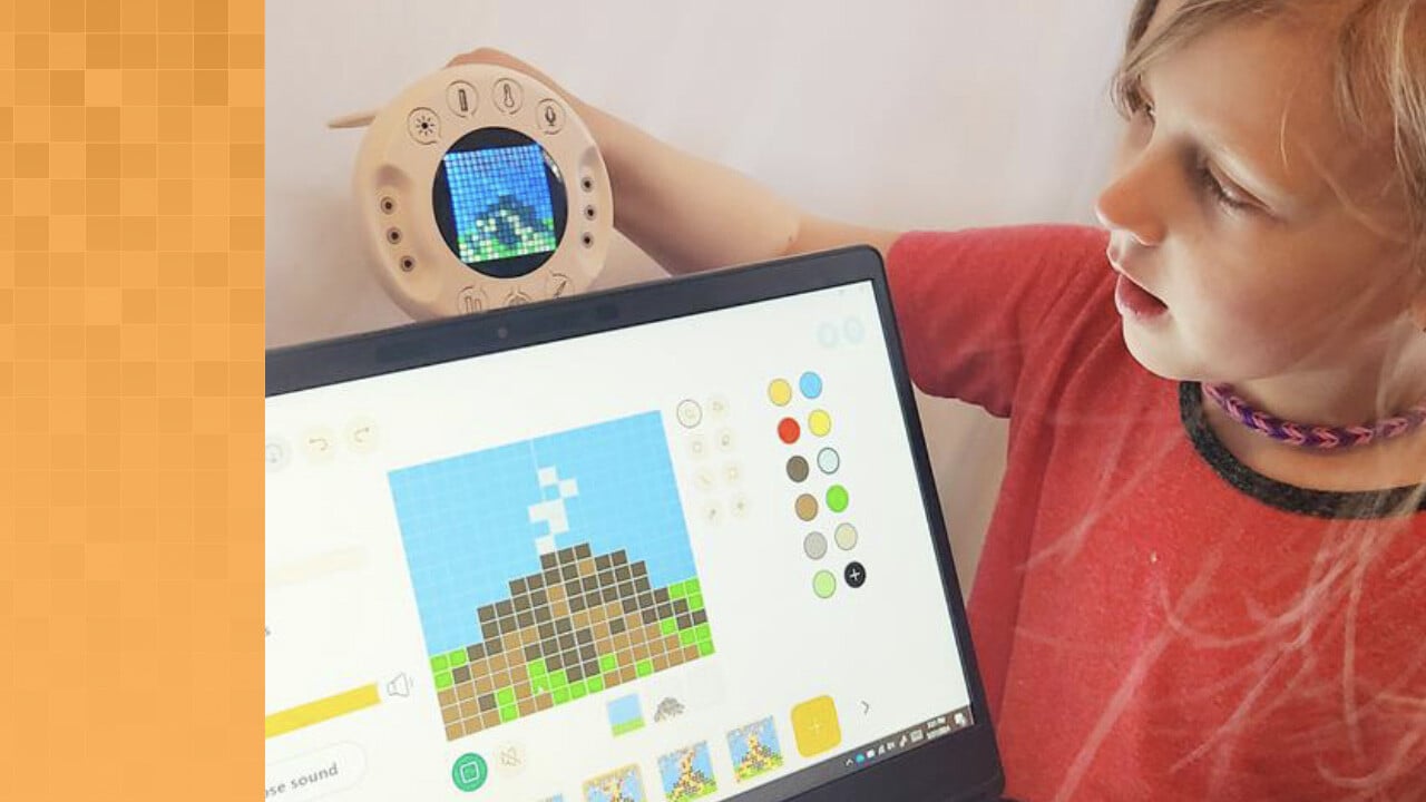 Young student holding an Xploris over a laptop screen. Both the Xploris grid and the laptop screen show an image of a pixelated mountain. The laptop screen also shows how the animation will be added to the mountain image.