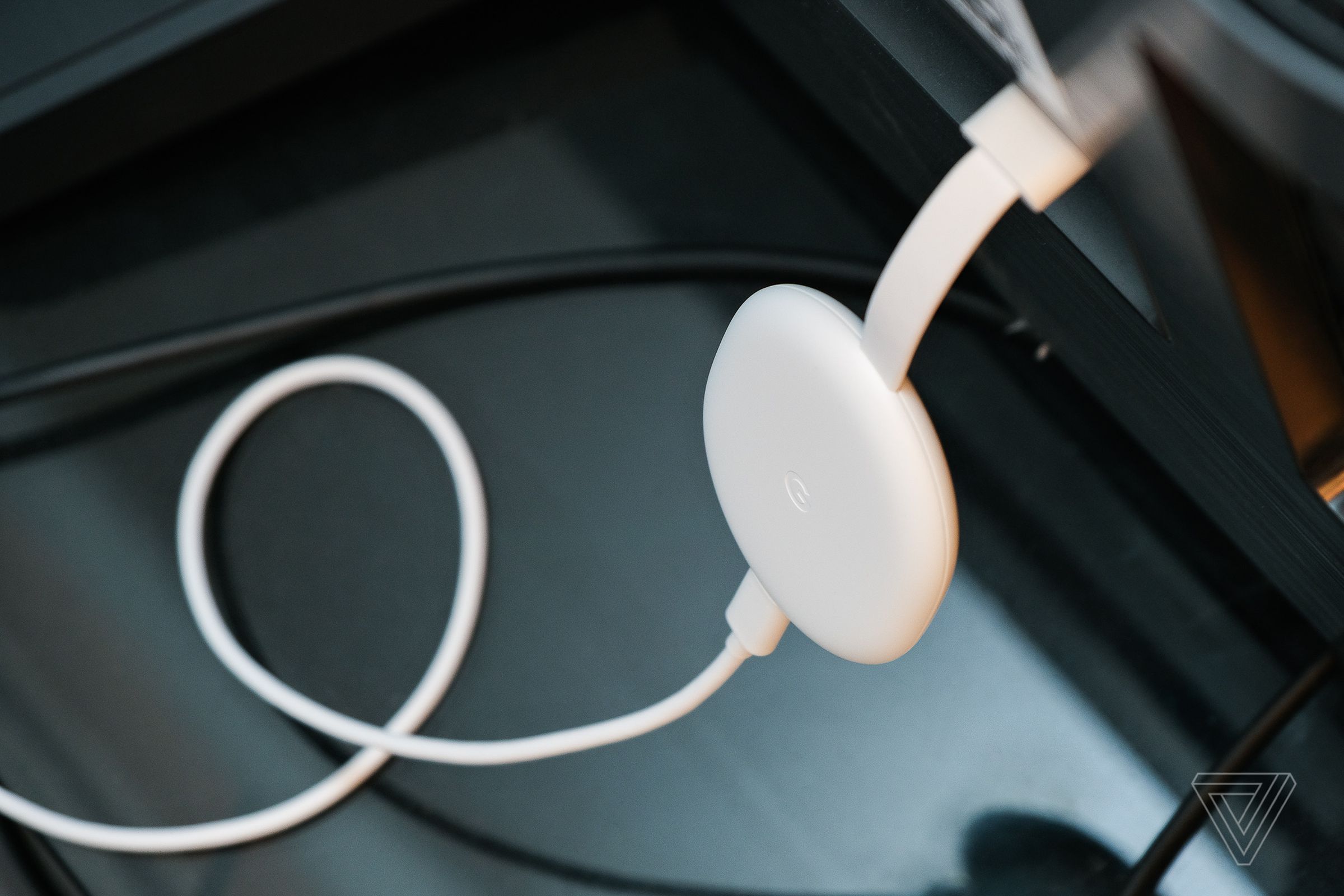 An image of the Google Chromecast, the best streaming stick of 2021 for most people, resting on a soundbar.