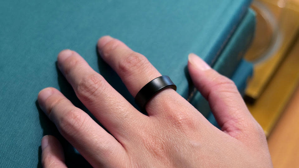 A hand carrying the Samsung Galaxy Ring.