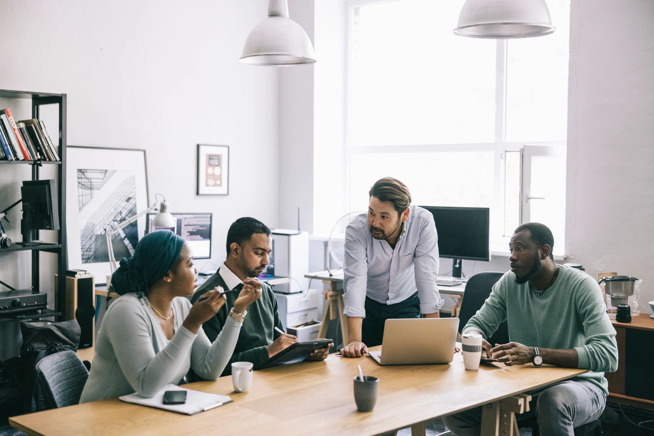 Small business team meeting with laptops