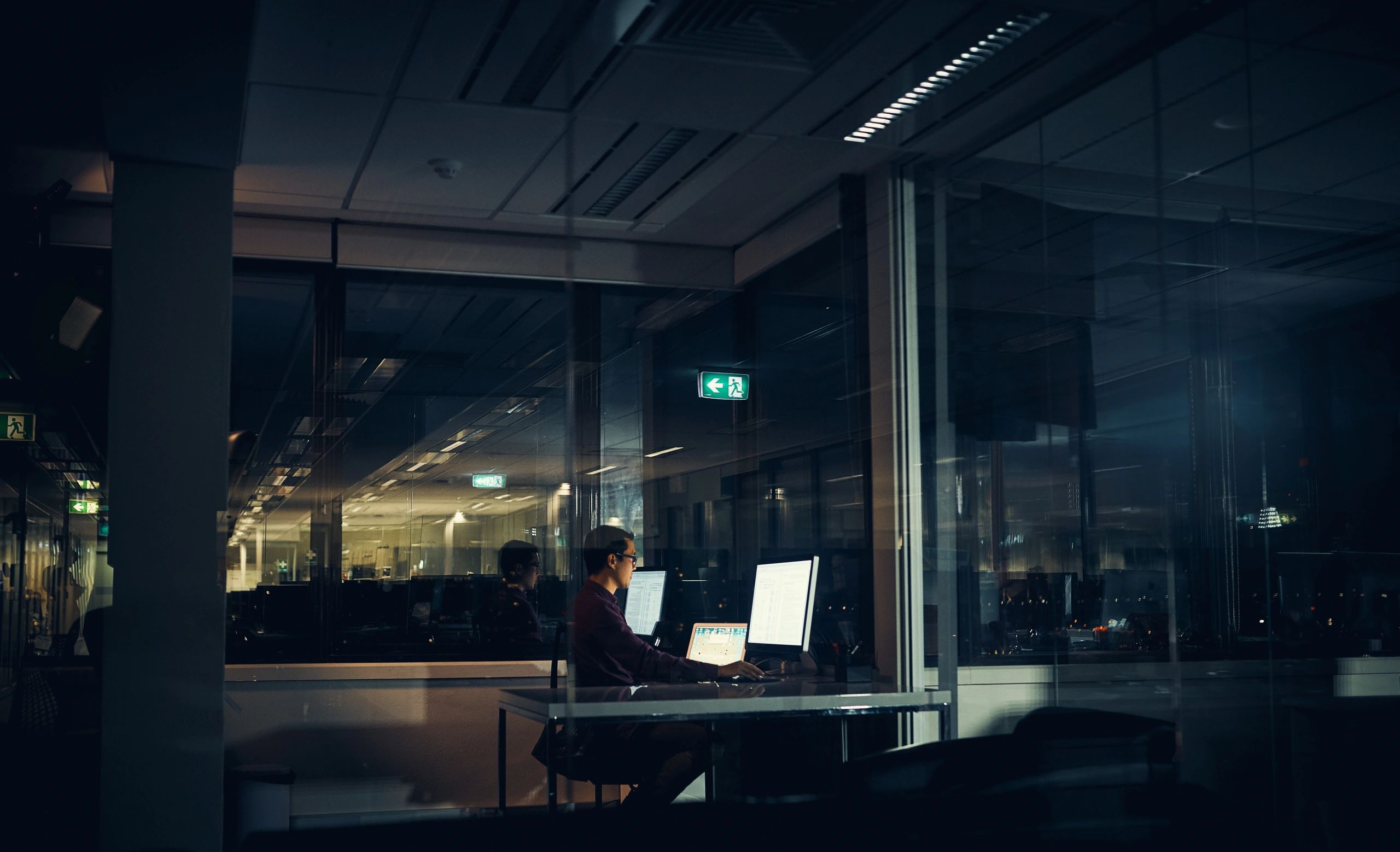 Businessman working late on a laptop in an office